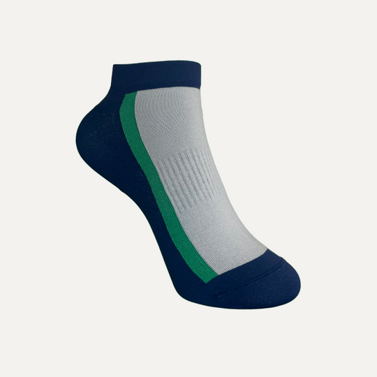 A single ankle sock with a navy blue toe, heel, and cuff, a light gray body, and a green stripe running along the side.
