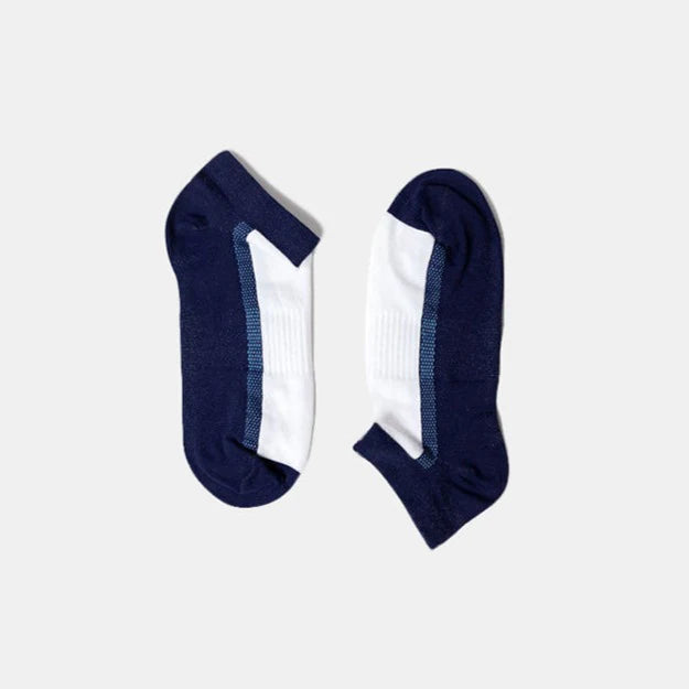A pair of low-cut socks with navy blue heels and toes and white midsections, displayed flat on a light grey background.