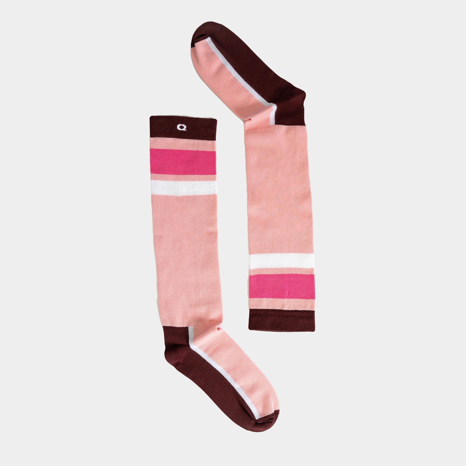 A pair of knee-high socks with pink, white, and magenta stripes, featuring brown toes, heels, and cuffs, displayed on a light background.