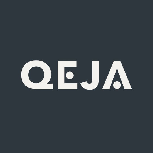 White, bold, geometric letters spelling QEJA on a dark gray background. The E and A each feature a circular dot, giving the text a modern, minimalist design.
