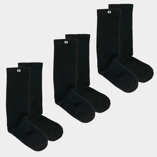 Three pairs of plain black crew socks with a small white logo near the top, arranged side by side on a white background.