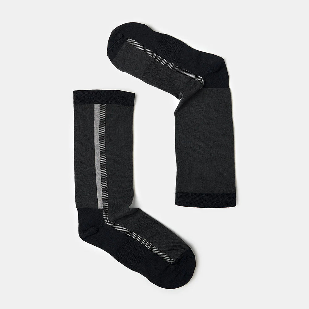 A pair of dark gray socks with black heels and toes, featuring a vertical light gray stripe near the cuff, laid flat on a light gray background.