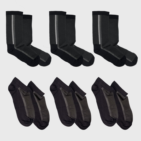 Six pairs of socks are shown: three pairs of dark crew socks with a vertical gray stripe and three pairs of dark ankle socks with ribbed detailing, all laid out on a light background.