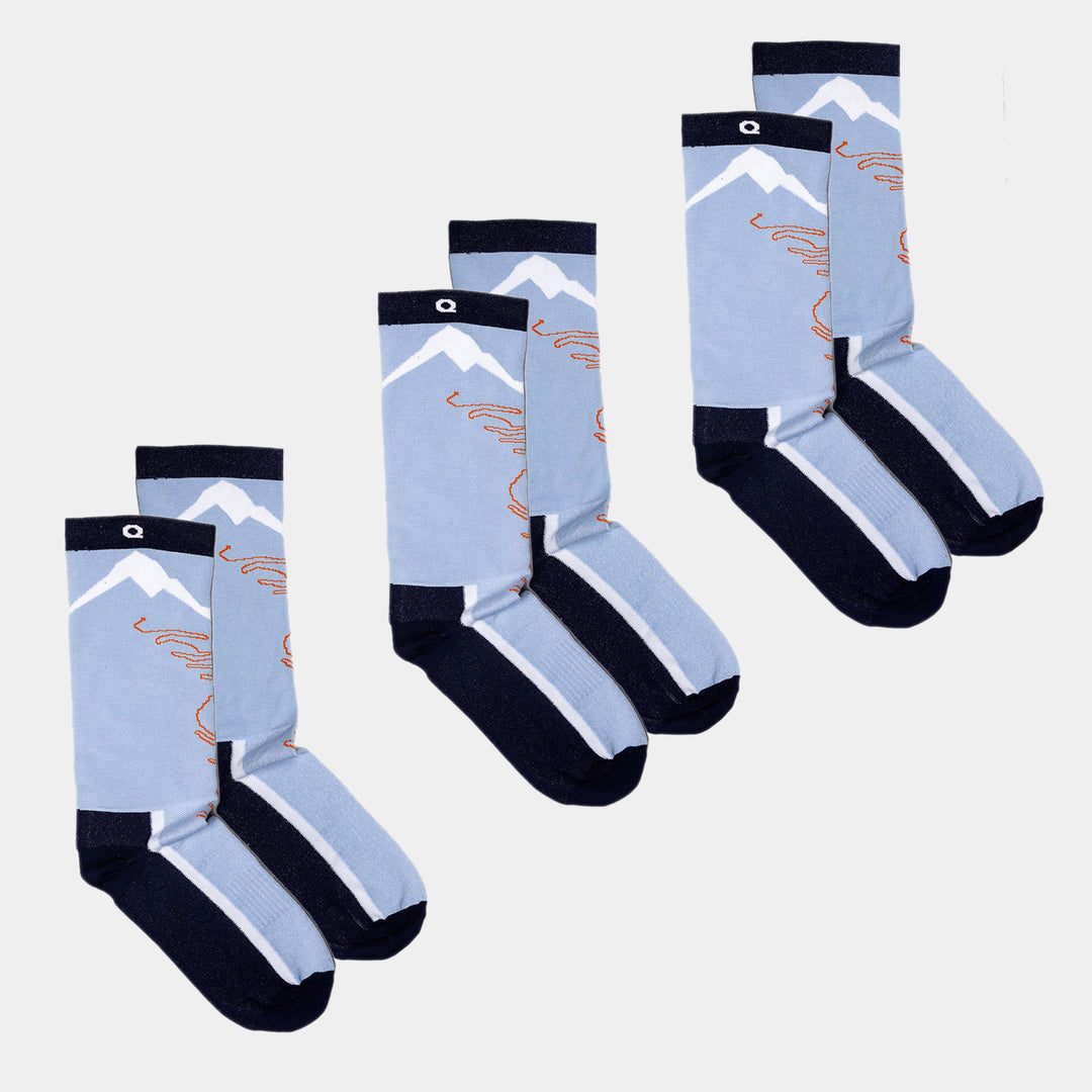 Four pairs of light blue and navy socks with mountain and wavy line designs, arranged side by side on a white background.