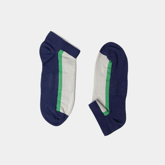 A pair of ankle socks with navy blue toes, heels, and cuffs, white midsections, and a green stripe running along each side, displayed on a plain light background.